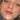 A very close up on a young ladies face while she is looking directly at the camera. Her lips are the focal point where you can see a brownish red color on her lips. This is the shade ladybug in lip tint.
