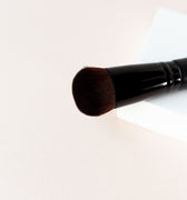 the top of the brush is shown. A black brush  with dark brown bristles. Short bristles tightly packed make up the chubby blender